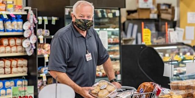 Shawn McAdams, manager of Rosauers in Colfax, shopping while wearing a mask