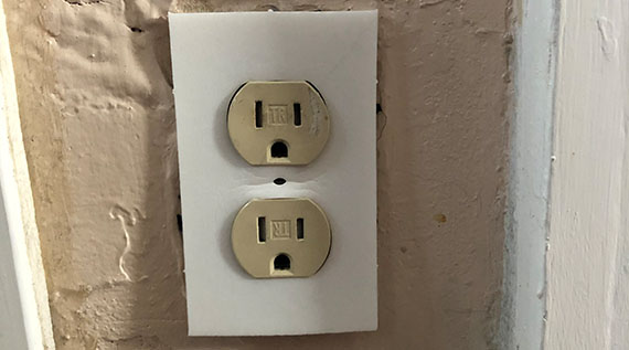 Wall outlet with an insulator being installed