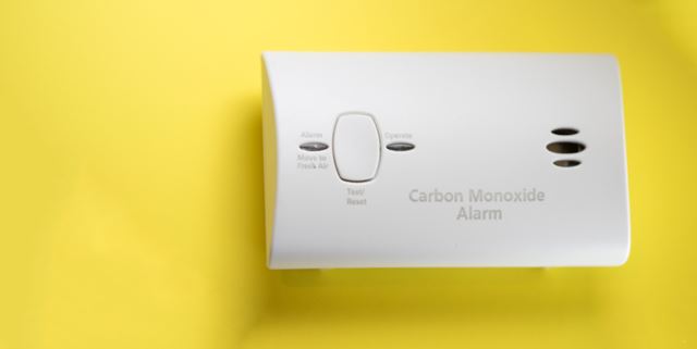 Carbon monoxide detector on yellow background