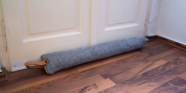 Long skinny pillow in front of a door to block drafts