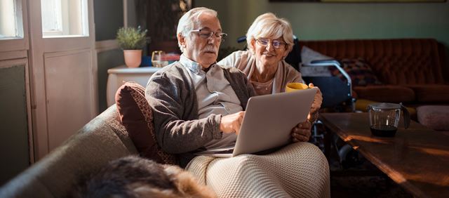Older couple on laptop at home