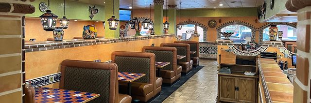 Booths at a Mexican restaurant with the lights on