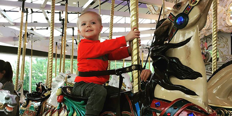 Child riding a horse on the Looff Carrousel
