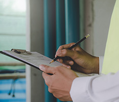 Closeup of hands holding a clipboard