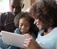 Mother and father with son on tablet