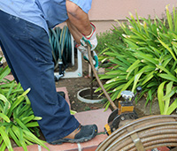 Man outdoors performing a cross bore inspection.