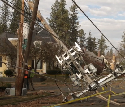 Power line broken in half, with the top half fallen over.