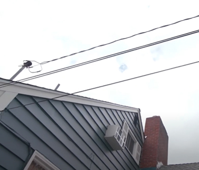 Power lines connecting to a house.