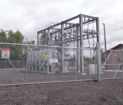 A substation behind a fence.